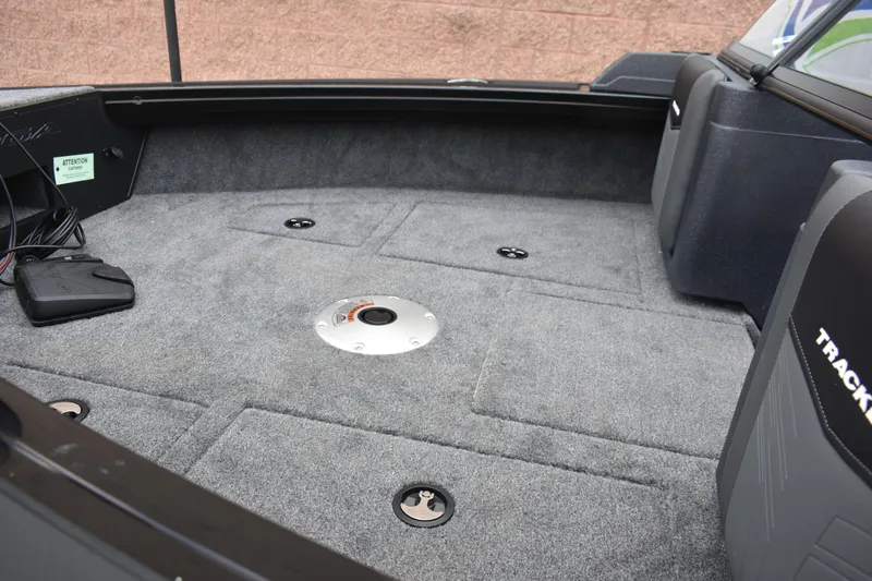Slide: The Image of 2026 Tracker Targa V-19 WT boat interior with carpeted deck and storage compartments. - 89