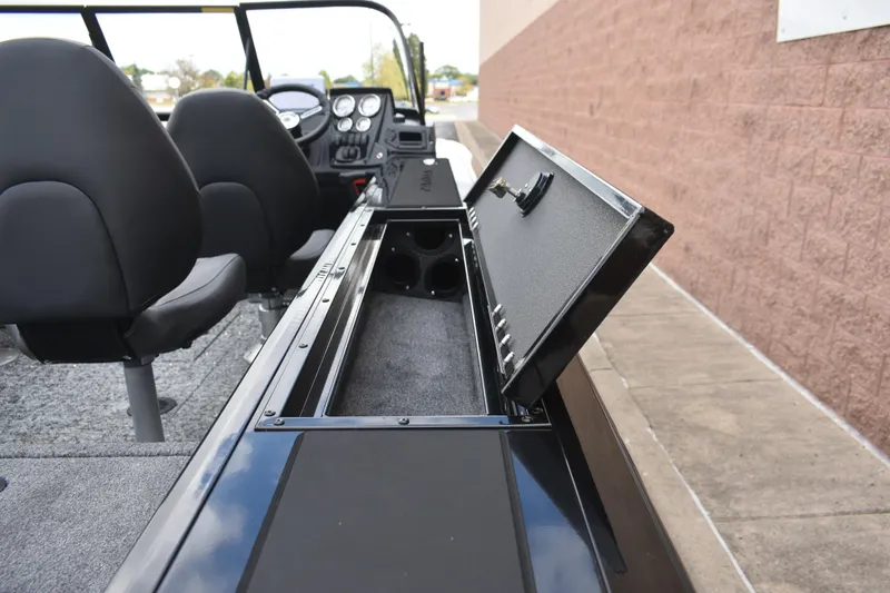 Slide: The Image of 2026 Tracker Targa V-19 WT boat interior with open storage compartment and seating. - 92