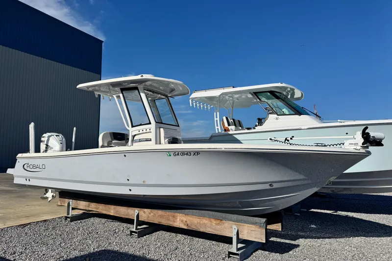 The Image of 2023 Robalo 266 Cayman boat displayed outdoors on a sunny day. - 1