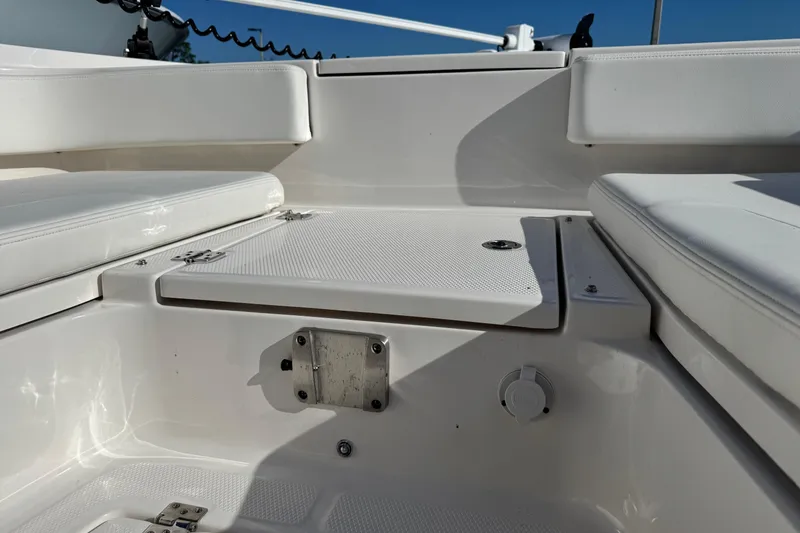 Slide: The Image of 2023 Robalo 266 Cayman boat interior seating and storage compartment. - 16