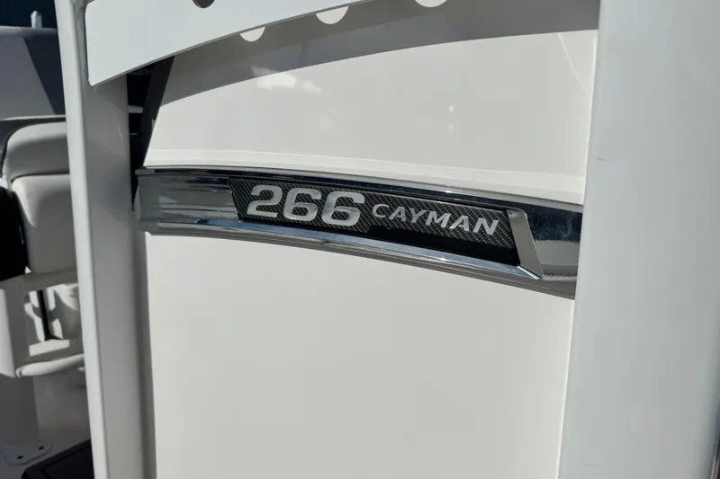 Slide: The Image of 2023 Robalo 266 Cayman boat emblem on white surface. - 19