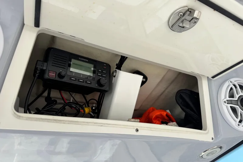 Slide: The Image of Storage compartment in 2023 Robalo 266 Cayman boat with Garmin device and accessories. - 24