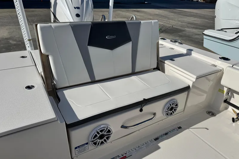 Slide: The Image of 2023 Robalo 266 Cayman boat seating area with integrated speakers and storage. - 27