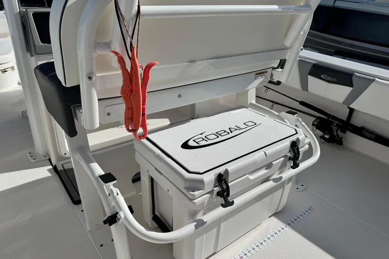Slide: The Image of 2023 Robalo 266 Cayman boat interior with storage compartment and fishing gear. - 28