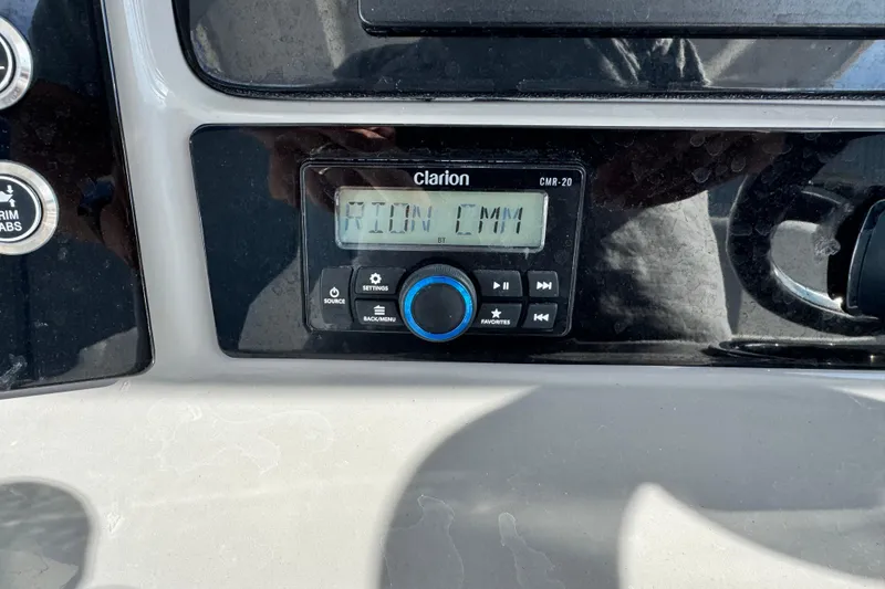 Slide: The Image of Clarion CMR-20 audio system on 2023 Robalo 266 Cayman boat dashboard. - 31