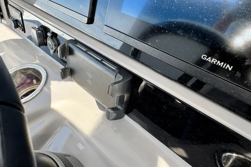 Slide: The Image of 2023 Robalo 266 Cayman dashboard with Garmin display and phone holder. - 32