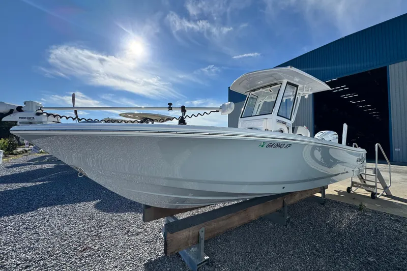 Slide: The Image of 2023 Robalo 266 Cayman boat displayed outdoors under a clear blue sky. - 5