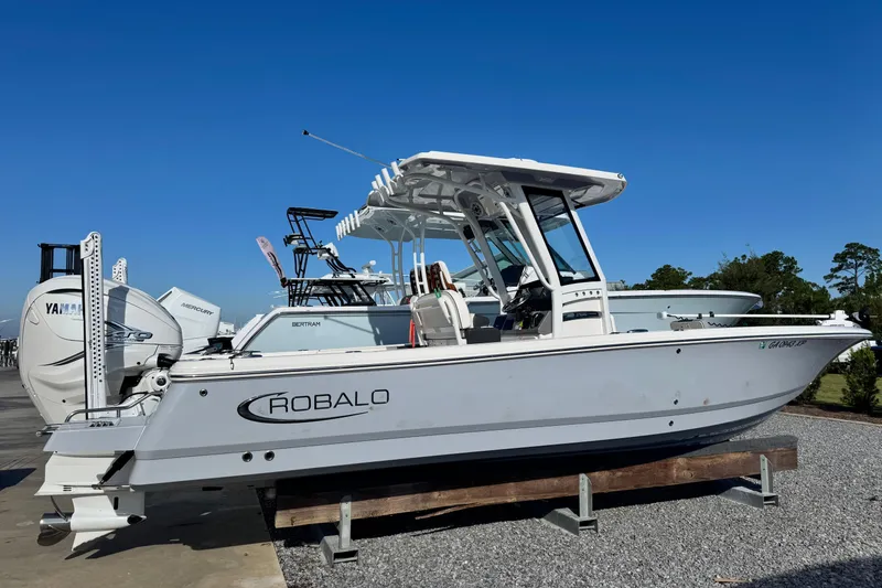 Slide: The Image of 2023 Robalo 266 Cayman boat displayed outdoors on a sunny day. - 8
