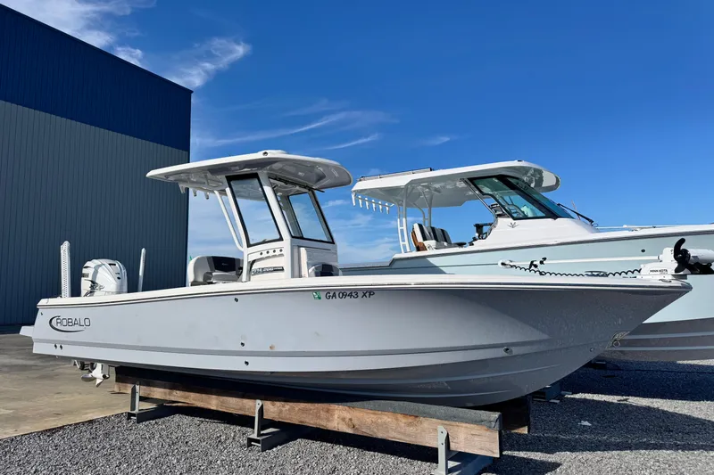 Slide: The Image of 2023 Robalo 266 Cayman boat displayed outdoors on a sunny day. - 9