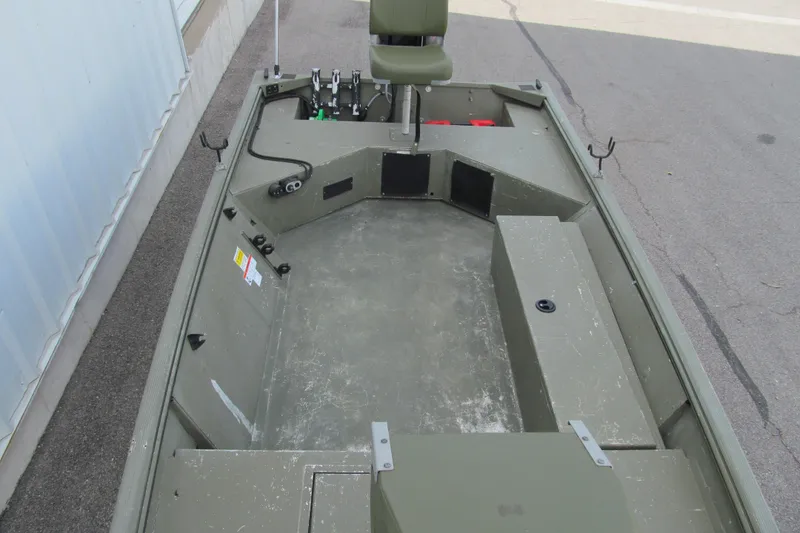 Slide: The Image of 2016 Lowe Roughneck 1650 boat interior with seating and storage compartments. - 10