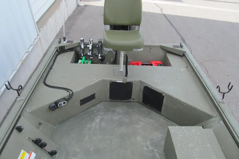 Slide: The Image of 2016 Lowe Roughneck 1650 boat interior with seating and storage compartments. - 11