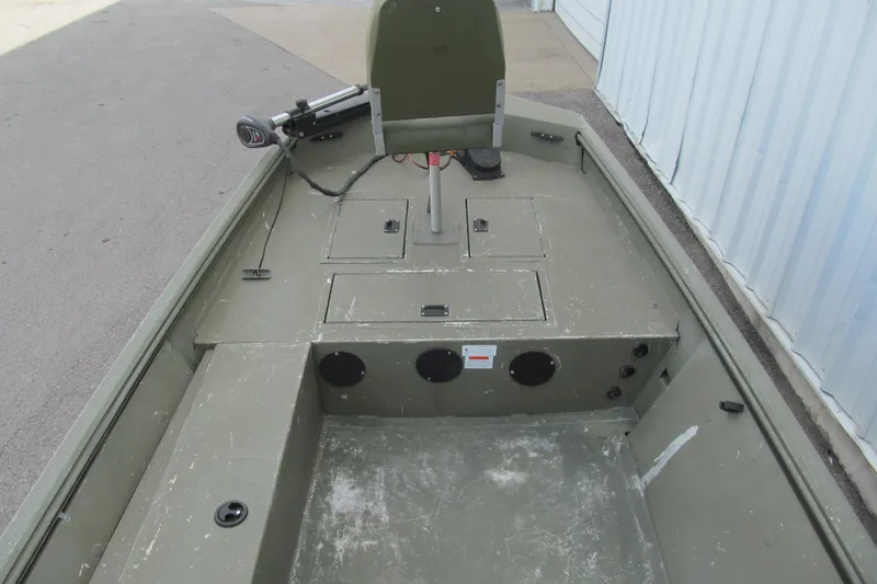 Slide: The Image of 2016 Lowe Roughneck 1650 boat interior with storage compartments and seating. - 6