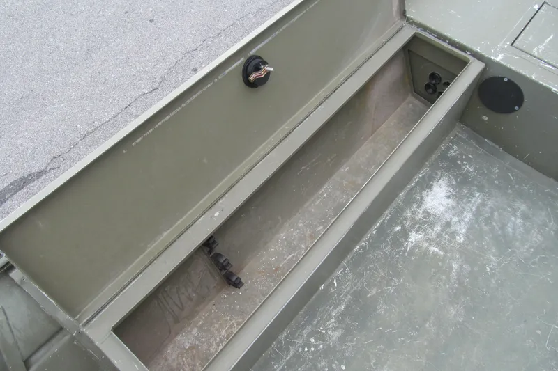 Slide: The Image of 2016 Lowe Roughneck 1650 boat interior storage compartment, open and empty. - 7