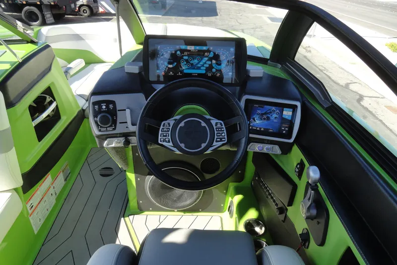 Slide: The Image of 2018 Malibu Wakesetter 24 MXZ boat cockpit with modern controls and digital displays. - 10