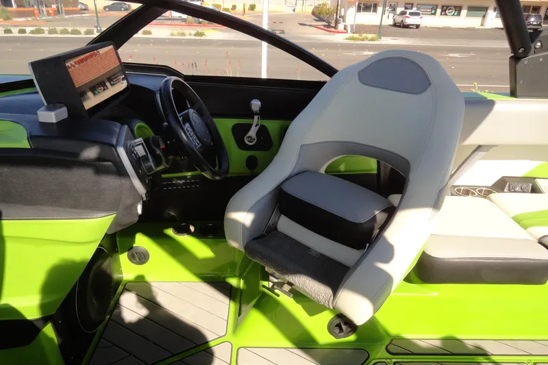Slide: The Image of Interior of 2018 Malibu Wakesetter 24 MXZ boat with green accents and modern dashboard. - 16