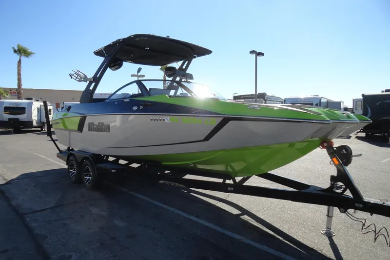 Slide: The Image of 2018 Malibu Wakesetter 24 MXZ boat on trailer, green and white design. - 4