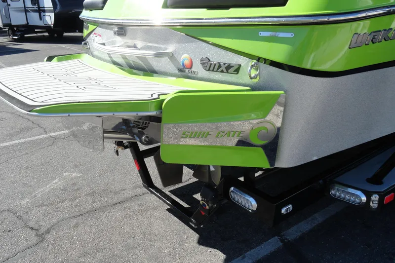 Slide: The Image of 2018 Malibu Wakesetter 24 MXZ with Surf Gate, vibrant green and silver design. - 7