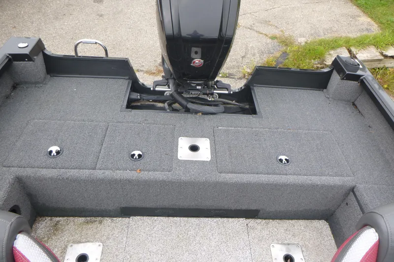 Slide: The Image of 2020 Ranger VS1682 WT boat interior with motor, featuring gray carpeted deck and storage compartments. - 13