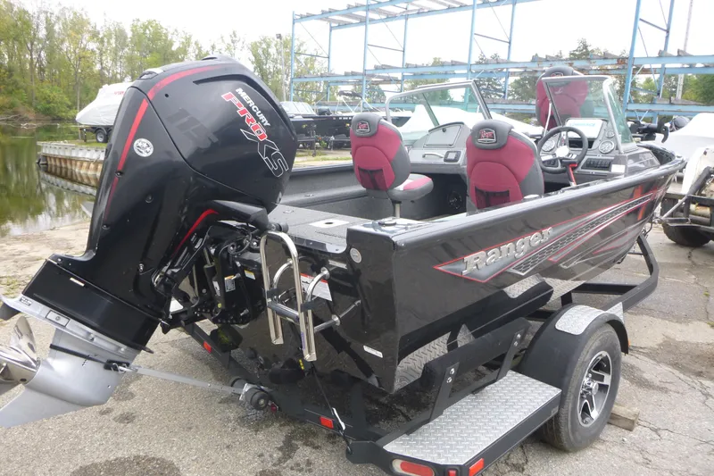 Slide: The Image of 2020 Ranger VS1682 WT boat with Mercury Pro XS engine, parked near a lake. - 2