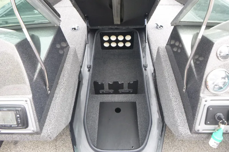 Slide: The Image of 2020 Ranger VS1682 WT boat interior with storage compartment and dashboard controls. - 9