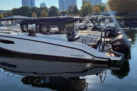 Slide: The Image of 2025 Navan C30 boat docked in a marina with city skyline background. - 10