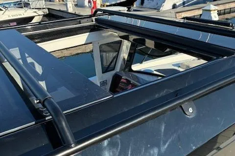 Slide: The Image of 2025 Navan C30 boat with open sunroof, docked at marina. - 24
