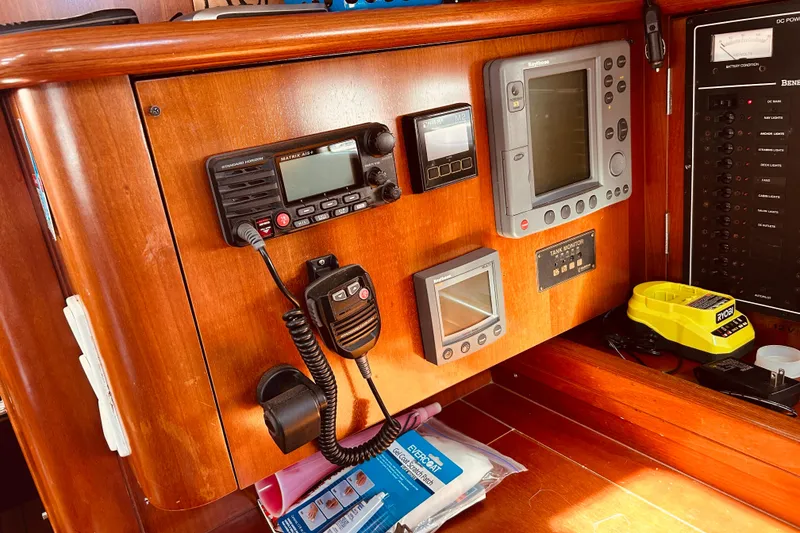 Slide: The Image of Control panel of a 2001 Beneteau 411 sailboat with navigation and communication equipment. - 14
