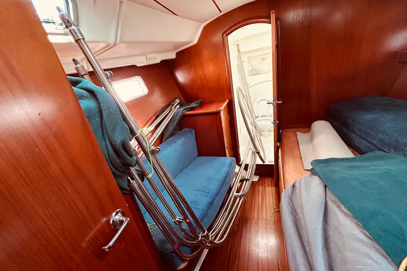 Slide: The Image of Interior of 2001 Beneteau 411 sailboat with cozy cabin and wooden finishes. - 20