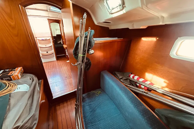 Slide: The Image of Interior of 2001 Beneteau 411 sailboat with wooden finish and cozy seating area. - 21