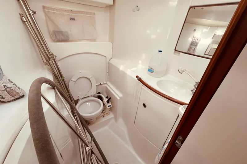 Slide: The Image of Beneteau 411 yacht bathroom, 2001 model, featuring toilet, sink, and mirror. - 22