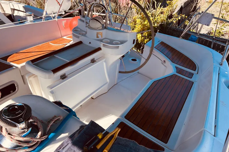 Slide: The Image of Cockpit of 2001 Beneteau 411 sailboat with wooden deck and steering wheel. - 25