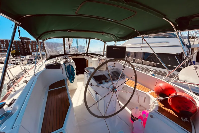Slide: The Image of Cockpit of 2001 Beneteau 411 sailboat with steering wheel and navigation equipment. - 26
