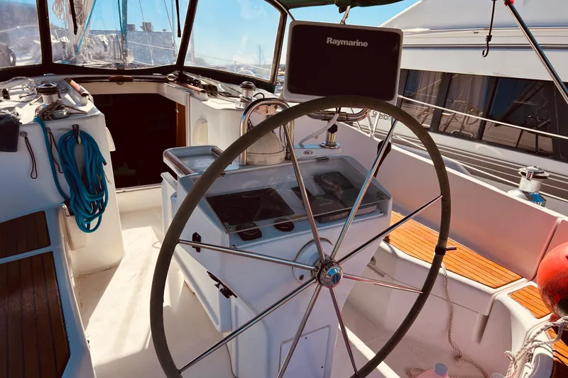 Slide: The Image of Cockpit of 2001 Beneteau 411 sailboat with steering wheel and navigation equipment. - 27