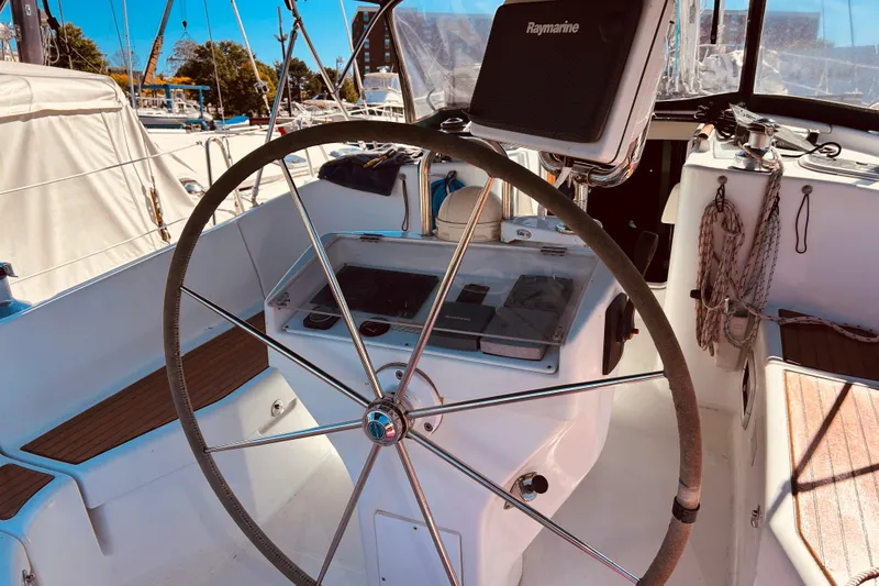 Slide: The Image of Steering wheel of a 2001 Beneteau 411 sailboat with navigation equipment. - 28