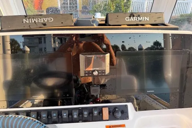 Slide: The Image of 2018 Sea Hunt BX 25 FS boat dashboard with Garmin navigation displays. - 14