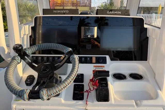 Slide: The Image of 2018 Sea Hunt BX 25 FS boat dashboard with Garmin navigation and wrapped steering wheel. - 15