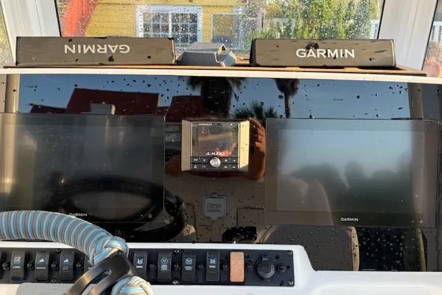 Slide: The Image of Dashboard of 2018 Sea Hunt BX 25 FS with Garmin navigation displays. - 16