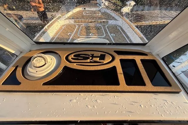 Slide: The Image of 2018 Sea Hunt BX 25 FS boat dashboard with SH logo and water droplets. - 17