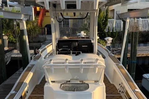 Slide: The Image of 2018 Sea Hunt BX 25 FS boat docked, featuring dual consoles and spacious deck. - 19