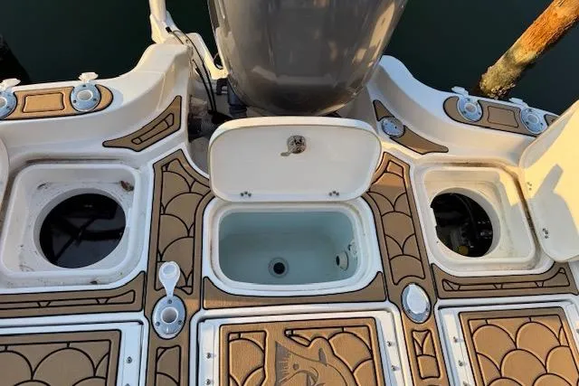 Slide: The Image of 2018 Sea Hunt BX 25 FS boat deck with storage compartments and motor. - 3