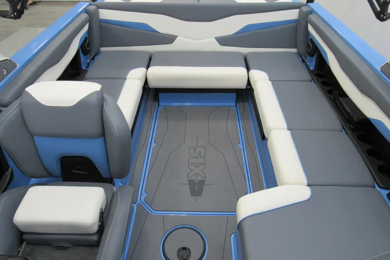 Slide: The Image of 2024 Axis T220 boat interior with blue and gray seating, spacious layout. - 10
