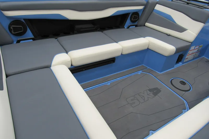 Slide: The Image of 2024 Axis T220 boat interior with gray and white cushioned seating and blue accents. - 4