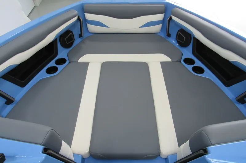 Slide: The Image of 2024 Axis T220 boat interior with blue and gray cushioned seating and cup holders. - 9