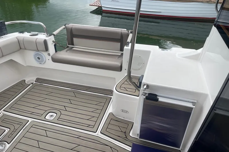 Slide: The Image of 2022 Cutwater C-30 Sedan boat interior with cushioned seating and wood-patterned flooring. - 16