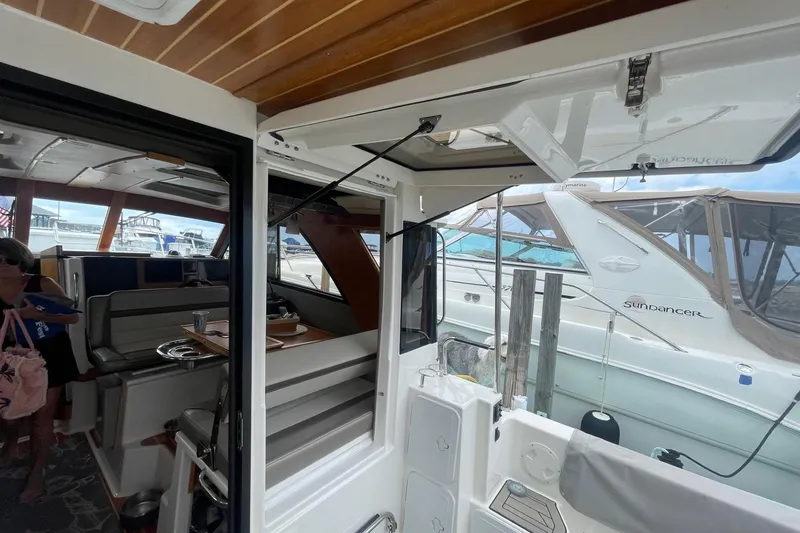 Slide: The Image of Interior view of 2022 Cutwater C-30 Sedan yacht at marina, showcasing seating and dining area. - 25