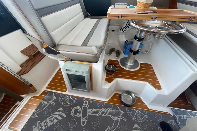 Slide: The Image of 2022 Cutwater C-30 Sedan interior with seating, table, and nautical-themed flooring. - 31