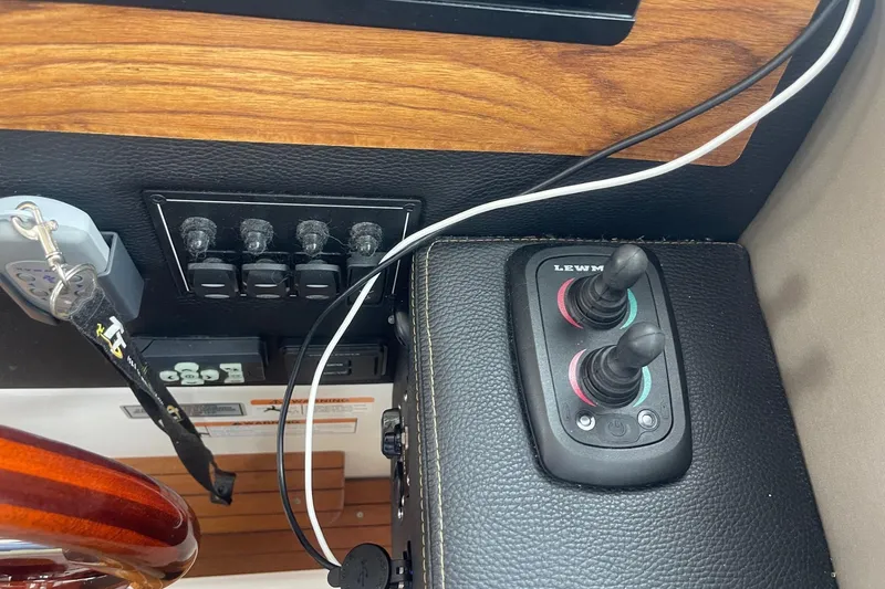Slide: The Image of Control panel of 2022 Cutwater C-30 Sedan boat with switches and joystick. - 54