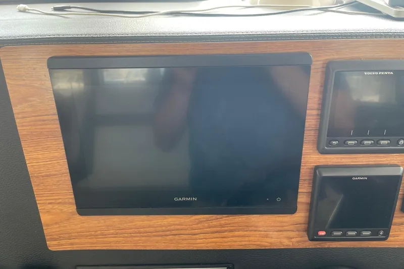 Slide: The Image of Garmin and Volvo Penta displays on 2022 Cutwater C-30 Sedan dashboard. - 56