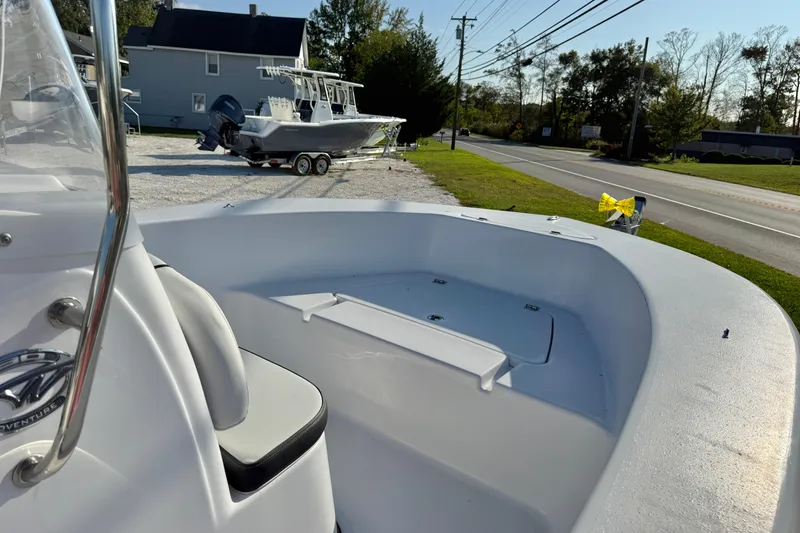 Slide: The Image of 2026 Tidewater 180 CC Adventure boat, sleek design, white exterior, sunny day, outdoor display. - 10