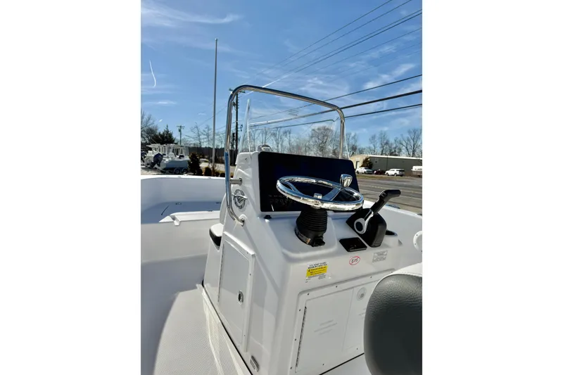 Slide: The Image of 2026 Tidewater 180 CC Adventure boat console with steering wheel and controls. - 12